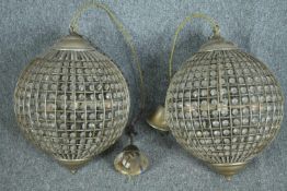 A pair of spherical beaded crystal glass and metal pendant light fittings. H.70cm.