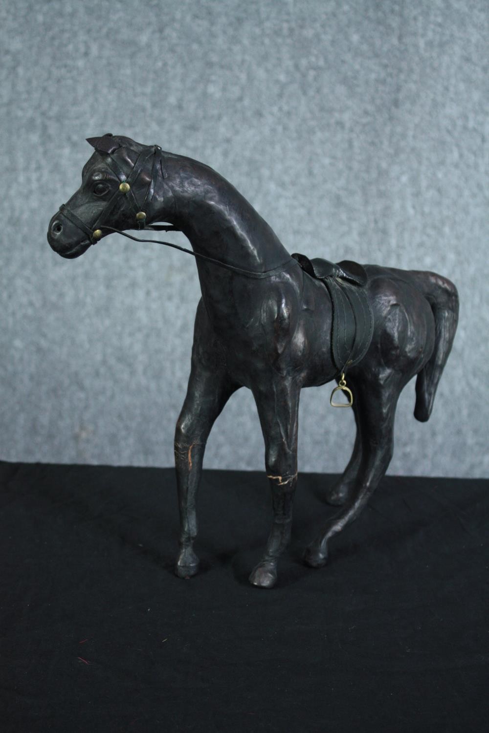 A well carved and detailed horse with leather bridle. Showing signs of past repairs. H.31 W.36 cm. - Image 3 of 5