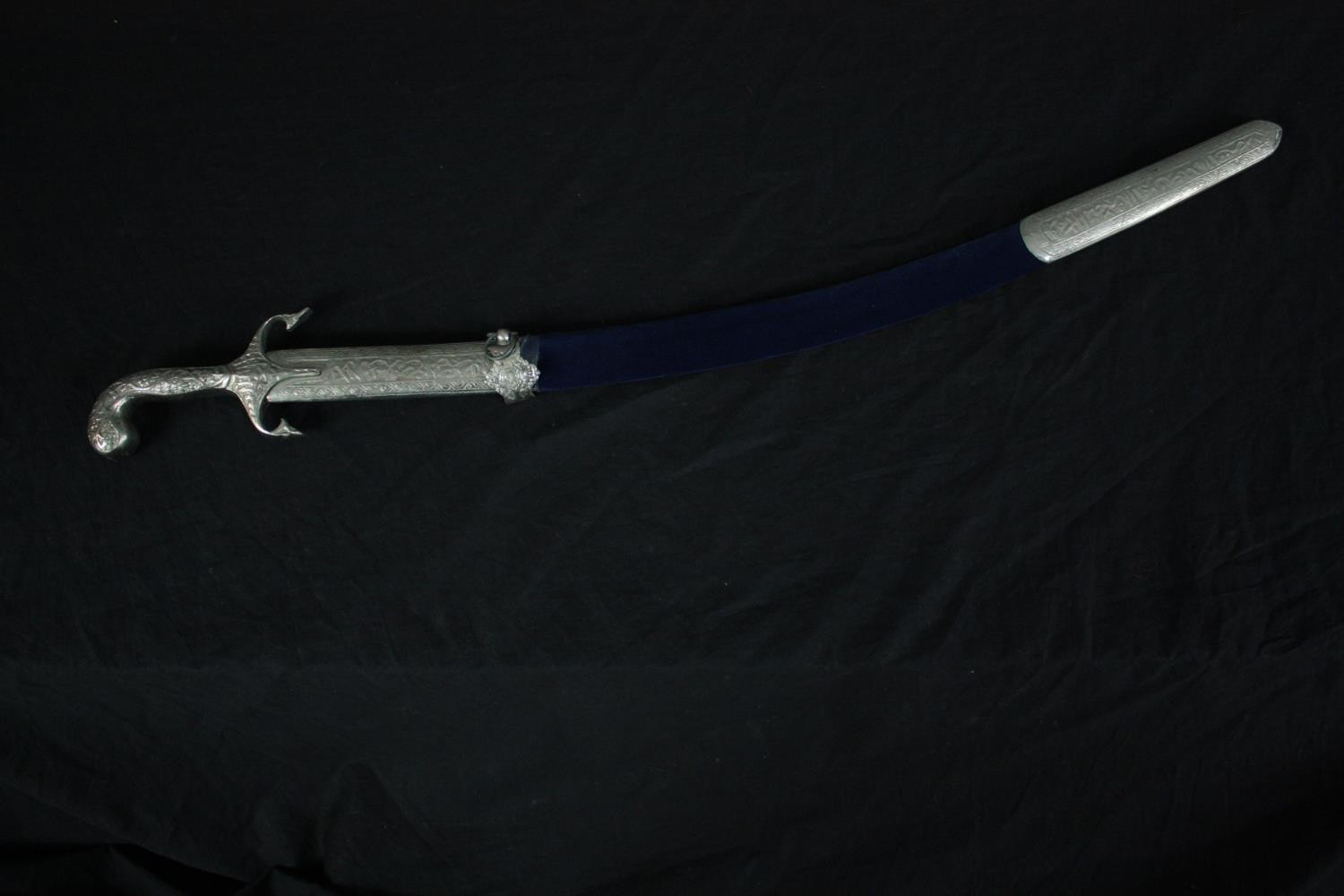 A ceremonial Indian sword with a velvet covered scabbard. The clasp is loose and will need