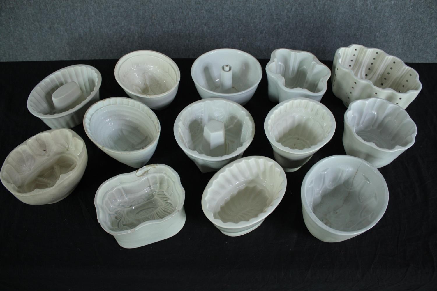 A collection of thirteen early 20th century stoneware and creamware jelly moulds of various designs. - Image 2 of 4