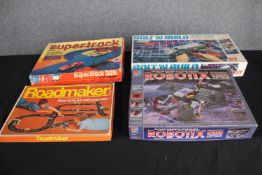 Four boxed vintage toy sets. Including 'Supertrack 22B', 'Bolt n' Build', 'Roadmaker' and 'Robotix'.