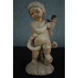 A carved cherub holding the charred remains of a torch or lantern. H.46 cm.