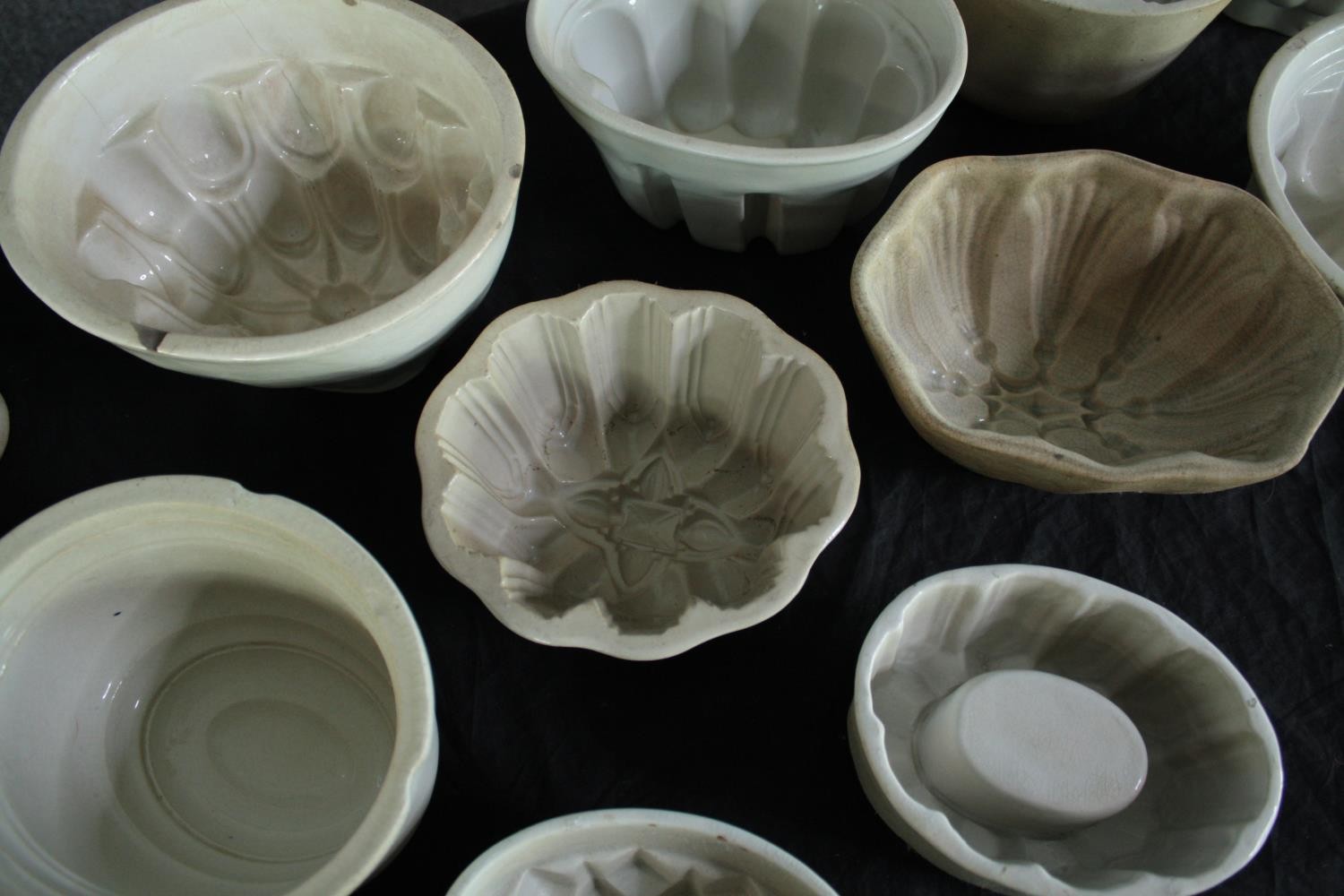 A collection of fifteen early 20th century stoneware and creamware jelly moulds of various - Image 4 of 5