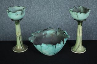 A pair of art pottery candle holders and a bowl. In the shape of cabbage leaves. Signed by the maker