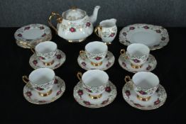 Roslyn fine bone China. Comprising of six cup and saucers, side plates, a creamer and teapot. H.
