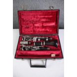 A Boosey and Hawkes clarinet. Complete and in its original felt lined case. L.35 W.23 cm.