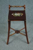 An early 19th century beech music stool with tapestry seat. H.61 W.30 D.41cm.