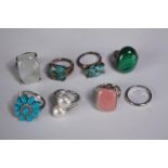 A collection of ten silver gem-set rings of various designs. Set with malachite, Turquoise, quartz