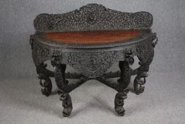 Console table, Burmese profusely carved hardwood. H.103 W.133 D.60cm.