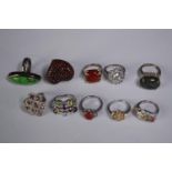 A collection of ten silver gem-set rings of various designs. Set with amber, Turquoise, fire opal