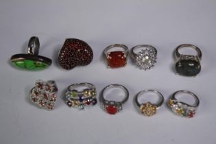 A collection of ten silver gem-set rings of various designs. Set with amber, Turquoise, fire opal