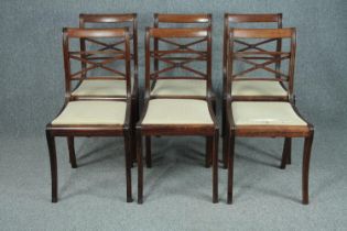 Dining chairs, a set of six 19th century rosewood on sabre supports.