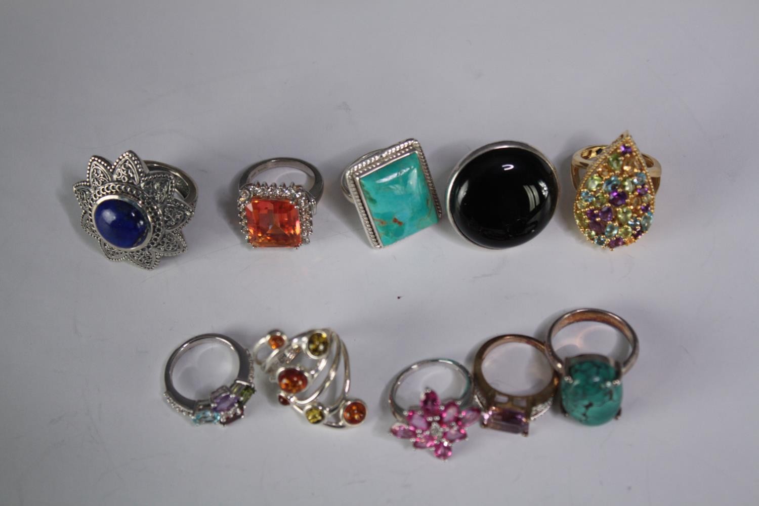 A collection of ten silver gem-set rings of various designs. Set with Blue topaz, Turquoise,