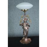 An Art Nouveau style figural lamp, woman holding a garland of flowers with a white glass shade. H.66