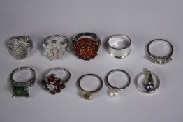 A collection of ten silver gem-set rings of various designs. Set with amber, opal, amethyst and