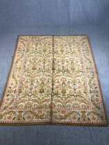 An Eastern woollen carpet with repeating scrolling foliate motifs across the pale primrose field