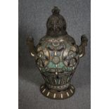 A Moroccan lidded twin handled ceramic urn with metal handles and base. Hand painted ceramic