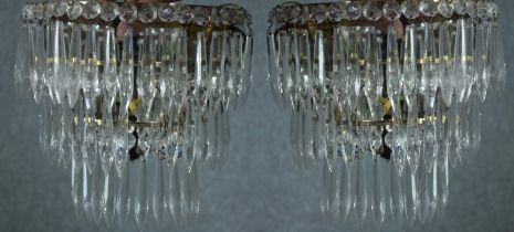 A pair of mirror backed crystal wall lights. Decorated with hanging teardrop glass. H.23 cm. (each)