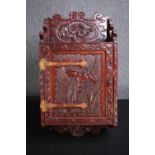 An Japanese carved wall mounted cabinet with Iris and Chrysanthemums. H.65 W.34 D.16cm.