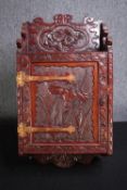 An Japanese carved wall mounted cabinet with Iris and Chrysanthemums. H.65 W.34 D.16cm.