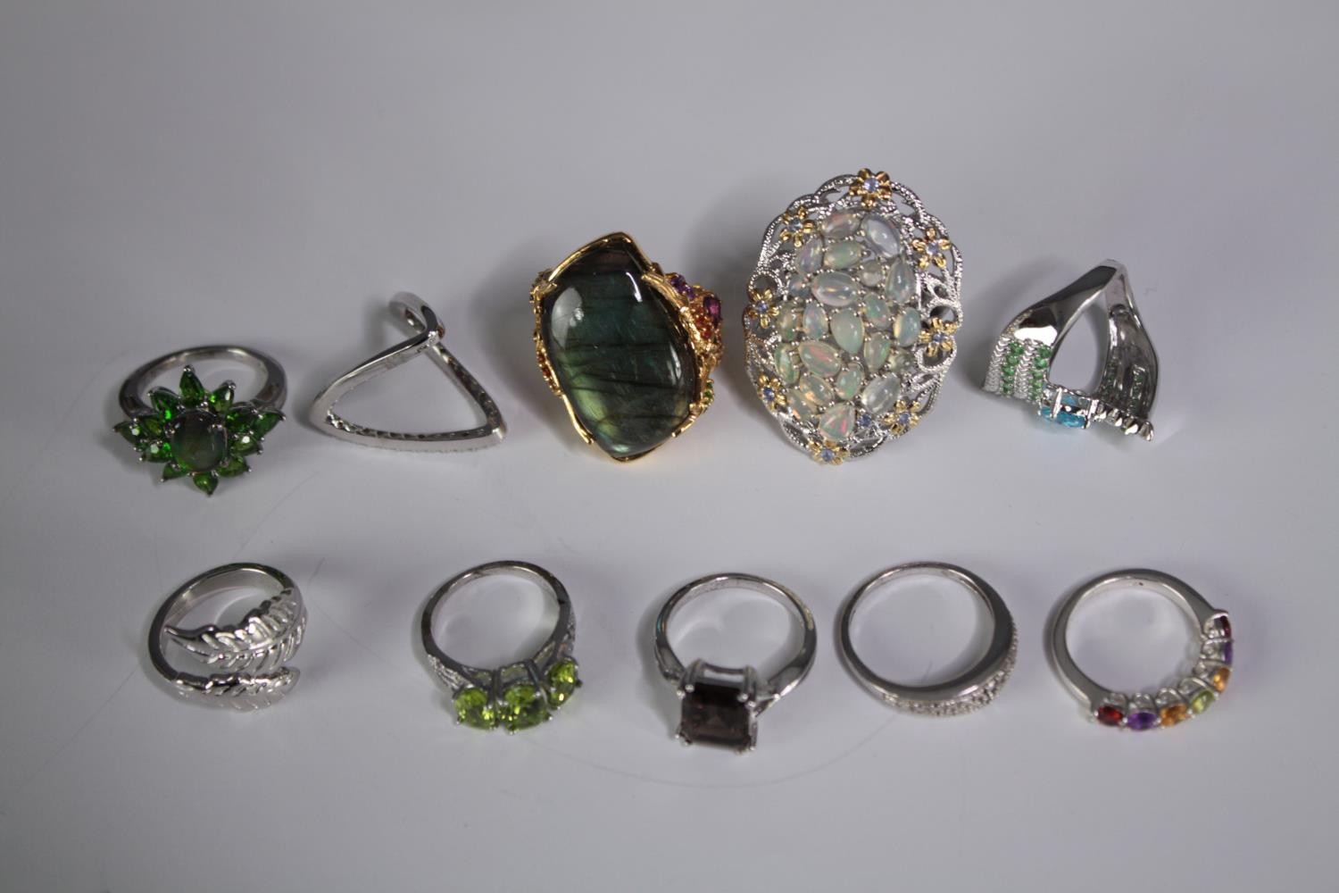 A collection of ten silver gem-set rings of various designs. Set with peridot, Labradorite, amethyst