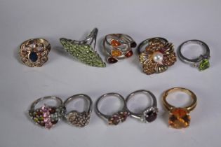 A collection of ten silver gem-set rings of various designs. Set with peridot, Tourmaline,