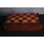 A boxed backgammon and chess board. Complete with all its pieces and leather leather dice shaker.