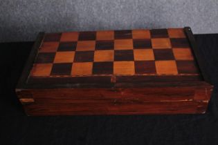 A boxed backgammon and chess board. Complete with all its pieces and leather leather dice shaker.