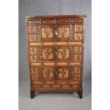 Tall cabinet, Chinese elm with allover applied brass decoration and banding. H.160 W.109 D.37cm. (