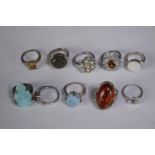 A collection of ten silver gem-set rings of various designs. Set with Fire opal, amber, amethyst and