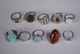A collection of ten silver gem-set rings of various designs. Set with Fire opal, amber, amethyst and