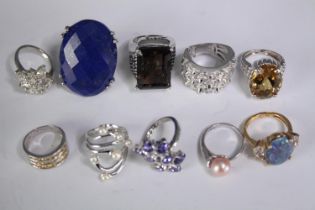 A collection of ten silver gem-set rings of various designs. Set with peridot, Tanzanite, Lapis