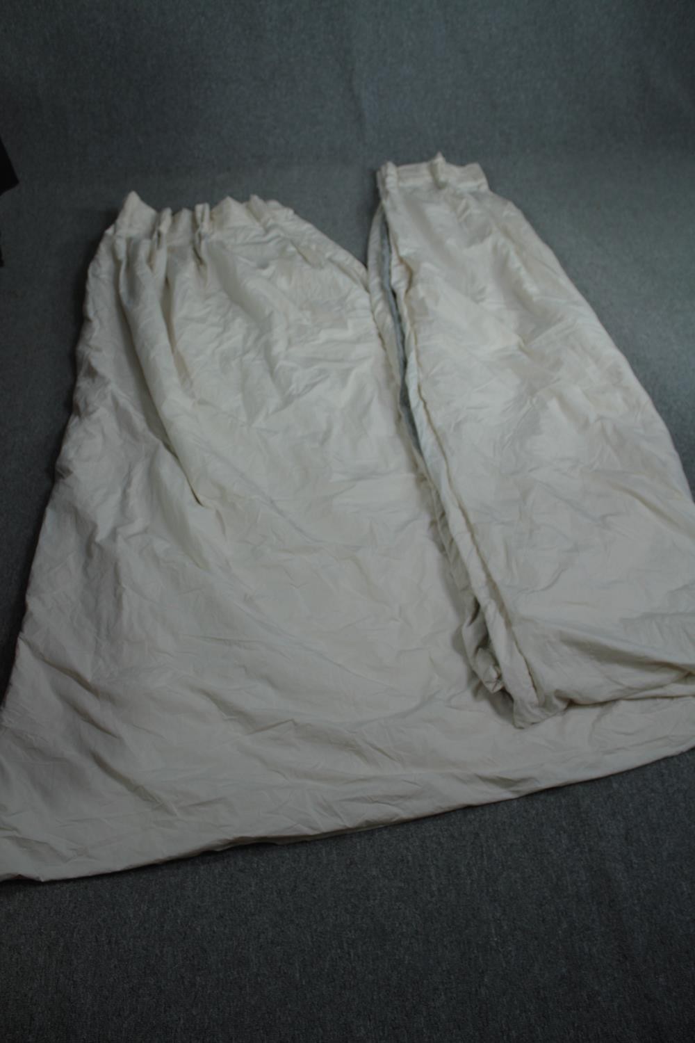 Pair of curtains. H.230 W.(top) 69cm. (bottom). 143 cm.