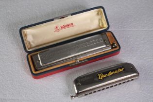 Two chromatic harmonicas made by Hohner and Bandmaster. L.22 W.6cm. (largest)
