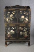 Cabinet, Chinese lacquered with allover applied decoration, in two sections. H.150 W.91 W.47cm.