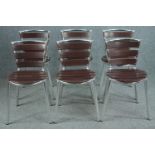 A set of six metal and faux wood slatted chairs.