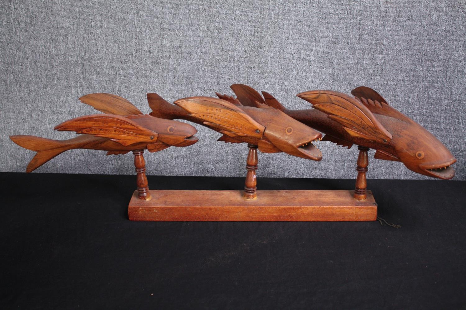 Two carved fish ornaments. Three fish mounted on a wooden stand, stamped Made by Clinton Warren, the - Image 2 of 8