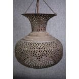 An Arabic pierced copper ceiling lantern. With a chain support. Aged with a patina. H.42cm.