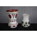 Two milk glass vases with gilt edging and floral decoration. One Bohemian cameo glass with cranberry