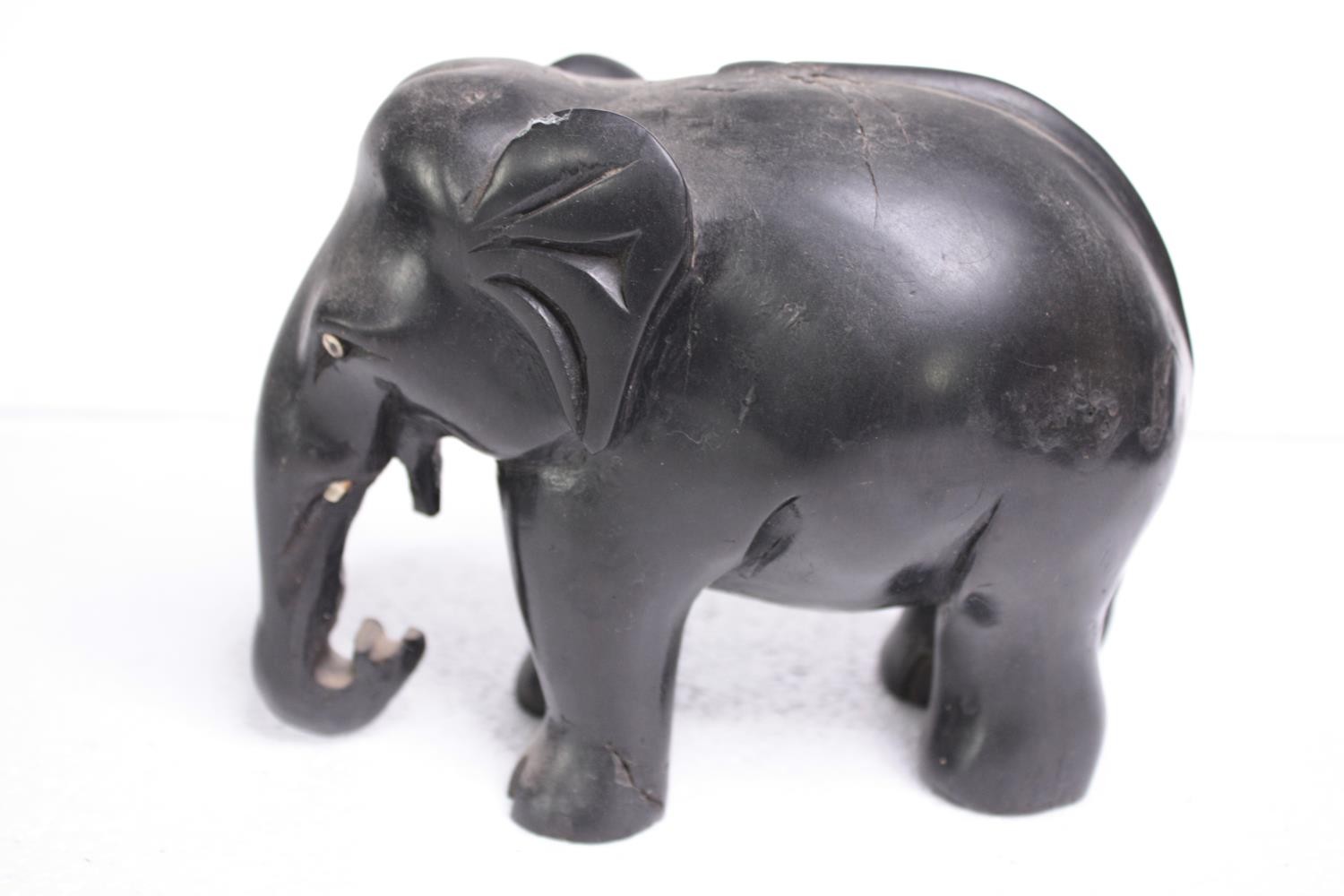 Two carved ebony elephants. Missing their tusks. Early to mid twentieth century. H.15 W.18cm. ( - Image 2 of 6