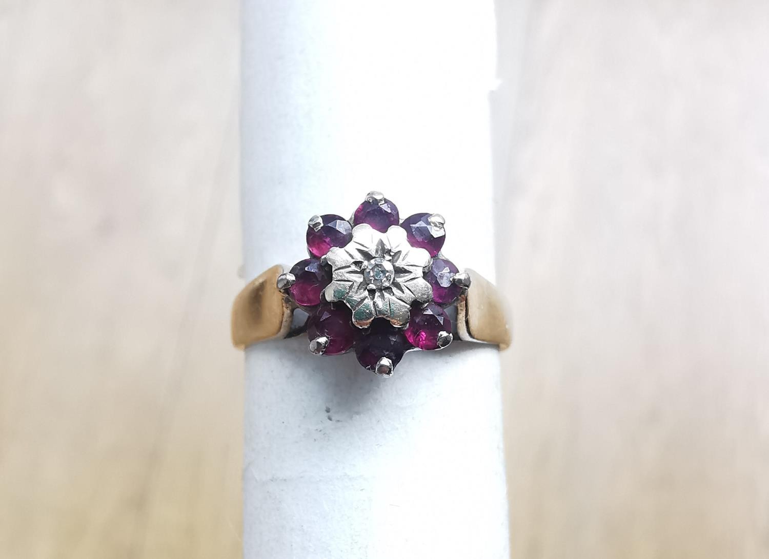 A pink metal (tests as 9ct) ruby and diamond cluster ring. Ring set to centre with a round eight cut - Image 3 of 4