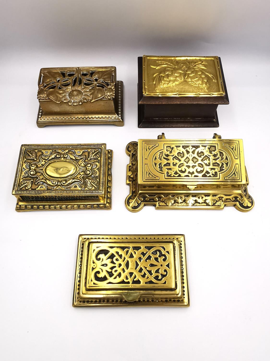 A collection of five 19th century and early 20th century brass stamp boxes, including one with a