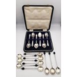 A collection of silver silver coffee spoons, including a leather cased set of silver coffee spoons