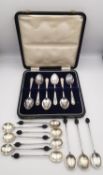 A collection of silver silver coffee spoons, including a leather cased set of silver coffee spoons