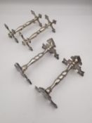 A collection of knife rests, a pair of Victorian silver knife rests with cross design ends by