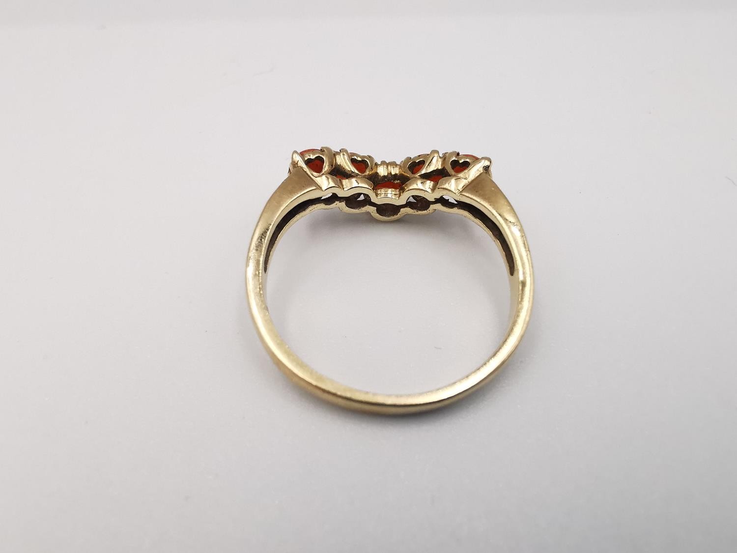 A 9ct yellow gold coral V-shaped ring. Set with five round red coral cabochons in open back claw - Image 4 of 4