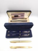 A collection of vintage ballpoint and fountain pens, including a suede cased set of royal blue