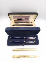 A collection of vintage ballpoint and fountain pens, including a suede cased set of royal blue