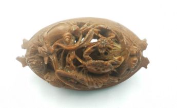 A early 20th century Chinese Hediao, one side intricately carved with grapes and mice, the other