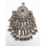 An early 20th century white metal Chinese silver Trade Dollar Omani pendant. The central coin with a